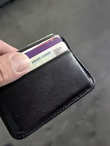 Primer plano del tarjetero negro sostenido en la mano